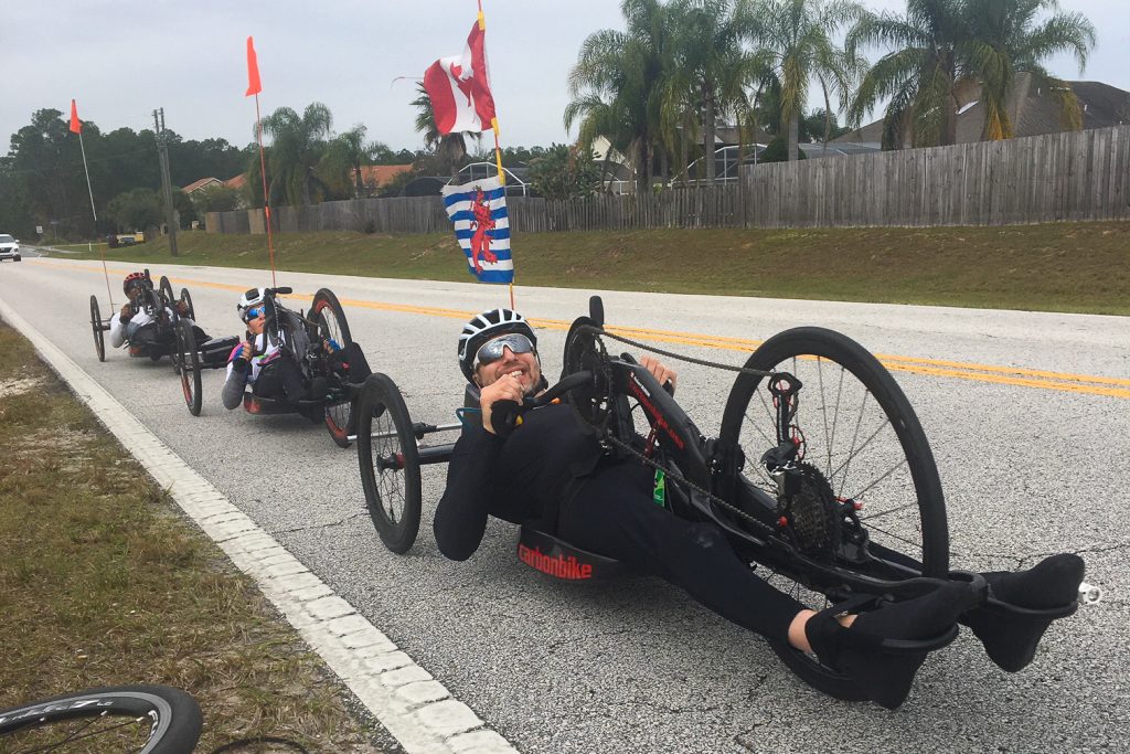 Para cyclists smiling on the road