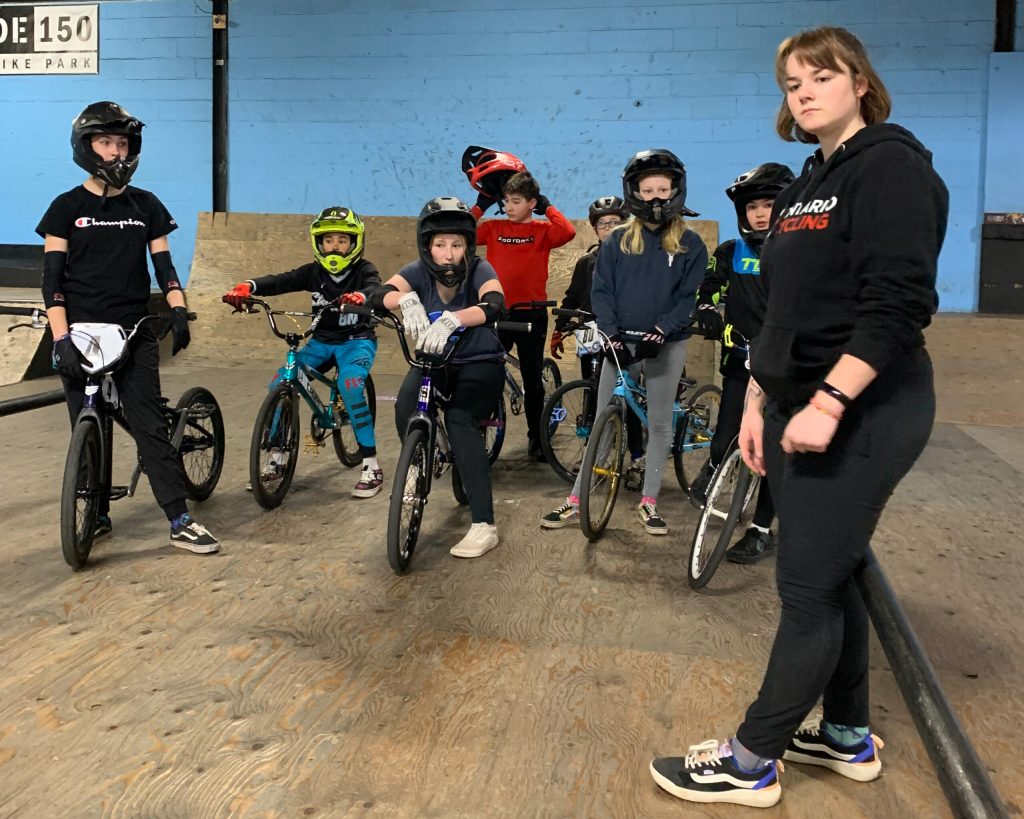 BMX Coach and campers evaluating the indoor bike park