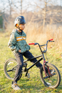 Child sitting on bike wearing Bold Helmet