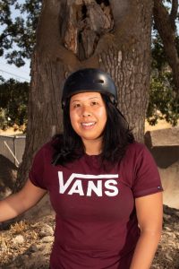 Beatrice Trang smiling in her bmx helmet and vans t-shirt